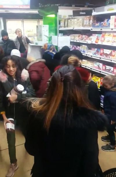 In this image taken from video a customer carries away pots of Nutella the chocolate and hazelnut spread, as others congregate around display of the product in a supermarket in Toulon southern France on Thursday Jan. 25, 2018. Brawls broke out in French supermarkets on Thursday as shoppers scrambled to get their hands on discounted pots of the chocolate and hazelnut spread Nutella. (AP)