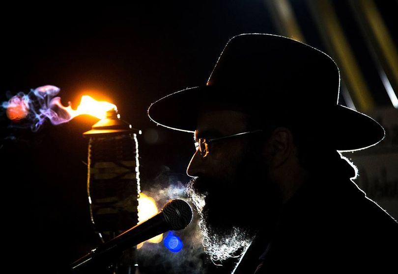 Before lighting a large menorah, Rabbi Yisroel Hahn speaks to the crowd gathered in Riverfront Park on Sunday. The Chabad of Spokane County community center presented the event in celebration of the eight-day Jewish Hanukkah holiday that began on the evening of Dec. 6. (Colin Mulvany / The Spokesman-Review)