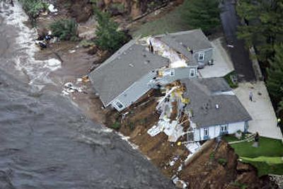 
A home  collapsed into Lake Delton, Wis., when floodwaters breached the bank and drained the lake Monday. Associated Press
 (Associated Press / The Spokesman-Review)