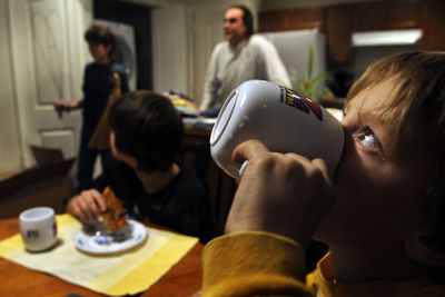 Seven-year-old Charlie Keillor drinks his milk during dinner at his new home, built in partnership by Habitat for Humanity of North Idaho in Post Falls.  (Kathy Plonka / The Spokesman-Review)