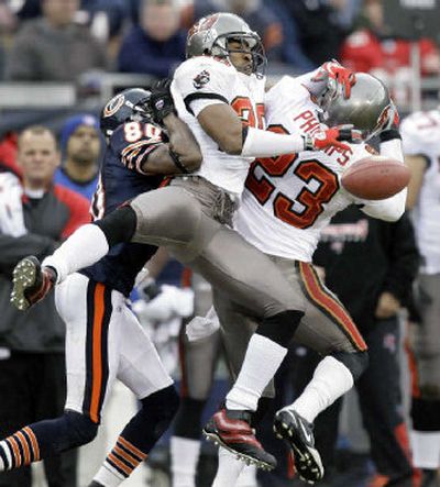 
Tampa Bay Buccaneers' Ronde Barber, center, and Jermaine Phillips, right, break up a pass. 
 (Associated Press / The Spokesman-Review)