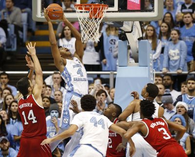 North Carolina forward Isaiah Hicks (4) goes to the basket against North Carolina State center Omer Yurtseven (14), guard Torin Dorn, center, and guard Terry Henderson (3) as North Carolina forwards Justin Jackson (44) and Kennedy Meeks, right rear, look on during the second half of an NCAA college basketball game Sunday, Jan. 8, 2017, in Chapel Hill, N.C. (Ellen Ozier / Associated Press)