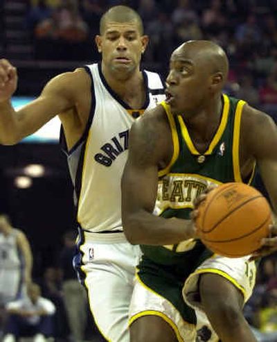 
Seattle's Damien Wilkins, right, fights his way around Shane Battier of the Memphis Grizzlies on his way to the basket in the first half Tuesday. 
 (Associated Press / The Spokesman-Review)