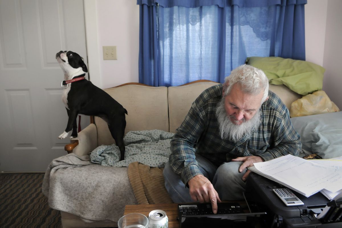 John “Herb” Friedlund and his dog, Tara, sit at his home near Eloika Lake on April 24, 2012. Friedlund was charged with stealing nearly $1 million from the retirement account of an elderly Kettle Falls woman. (Dan Pelle)