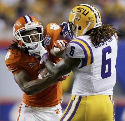 Clemson receiver DeAndre Hopkins clashes with LSU safety Craig Loston during the Chick-fil-A Bowl. (Associated Press)