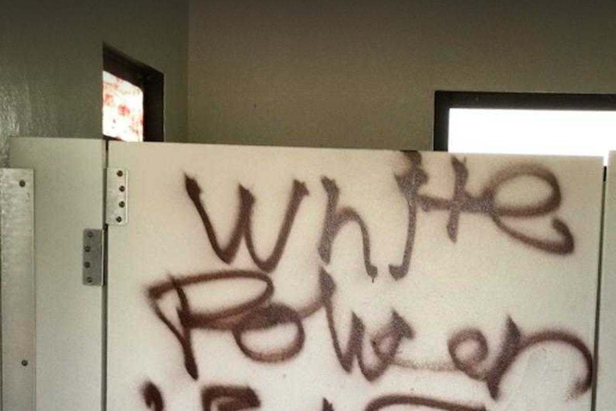 The words “White Power” were spray painted onto a stall door in the women’s restroom at Greenacres Park in Spokane Valley, as pictured on Saturday. This edited image occludes the four swastikas painted below the message. Other defacements to the space included racial slurs and obscenities.  (Courtesy of Becky Graham)