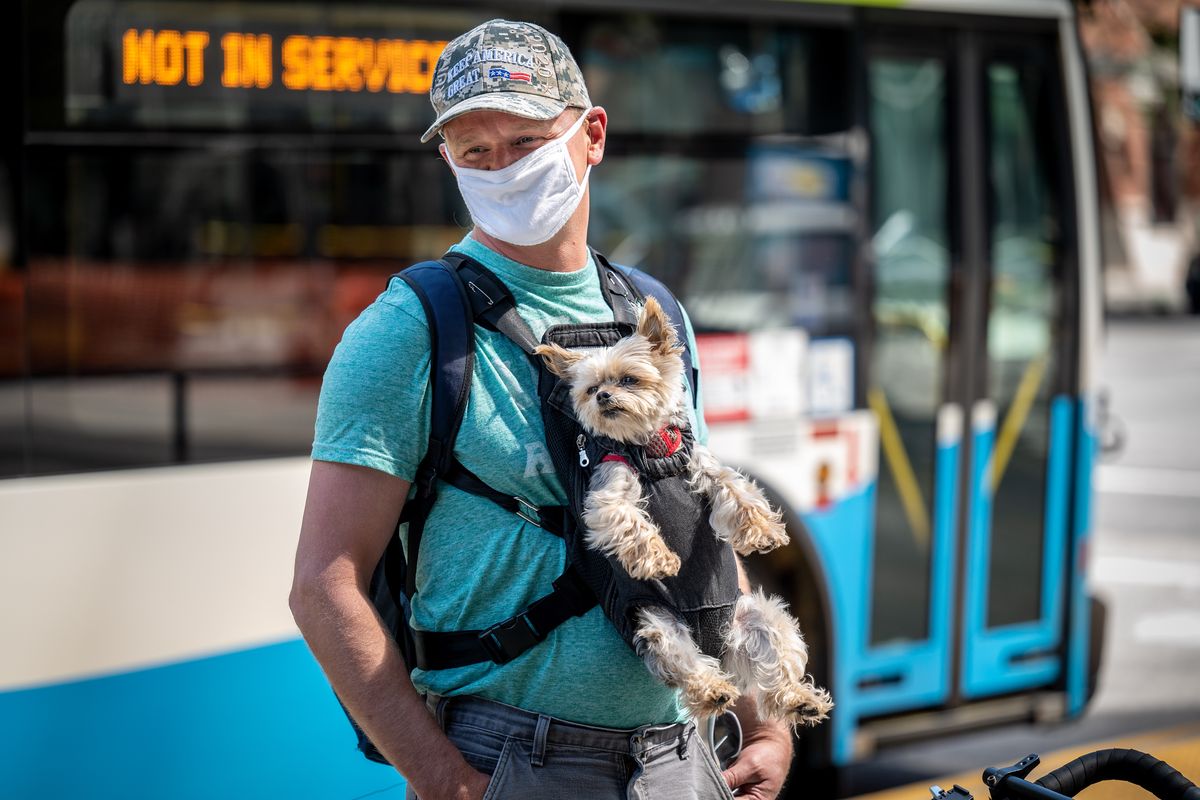 The CDC is recommending people wear masks indoors as the delta variant spreads and case counts climb. In this photo from May, Jeff Severson, with his dog Murphy said that even with being vaccinated against the COVID-19 virus, he will continue to wear a mask to protect himself.  (COLIN MULVANY/THE SPOKESMAN-REVIEW)