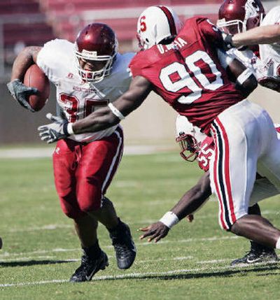 
WSU running back DeMaundray Woolridge tries to slip past Stanford's Udeme Udofia.
 (Associated Press / The Spokesman-Review)