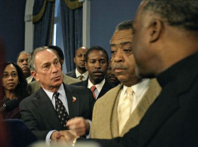 
New York City Mayor Michael Bloomberg, left, shakes hands with City Councilman Charles Barron as the Rev. Al Sharpton looks on following a meeting Monday at City Hall in New York. 
 (Associated Press / The Spokesman-Review)