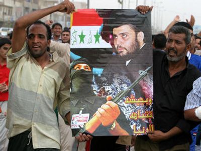 
People carry a poster showing radical Shiite cleric Muqtada al-Sadr, chief of the feared Mahdi Army militia, in Sadr City on Sunday. Hundreds protested a blockade of the Shiite enclave by U.S. troops. 
 (Associated Press / The Spokesman-Review)