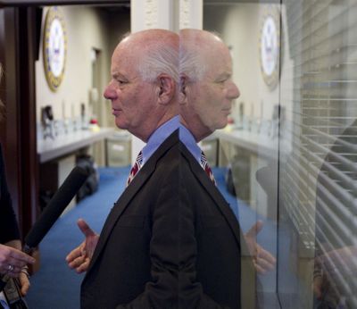 Sen. Ben Cardin, D-Md., is reflected in a window on Capitol Hill in Washington on Monday as he answers reporters’ questions following a news conference to discuss the upcoming jobs bill.  (Associated Press)