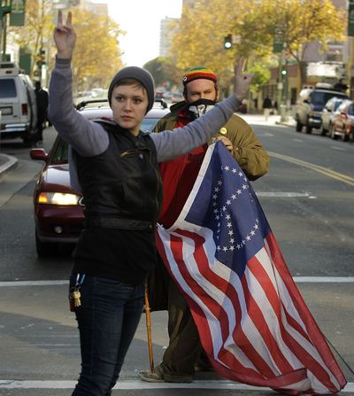 Occupy Oakland protestors block traffic from the intersection of 14th and Broadway in downtown Oakland, Calif., on Monday. (Associated Press)
