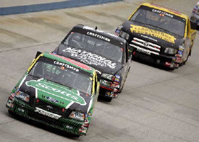 
Mark Martin, front, races past Kyle Busch and Todd Bodine to win in Dover, Del.
 (Associated Press / The Spokesman-Review)