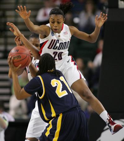 UConn’s Renee Montgomery jumps to block a shot by Cal’s Alexis Gray-Lawson in the first half. (Associated Press / The Spokesman-Review)