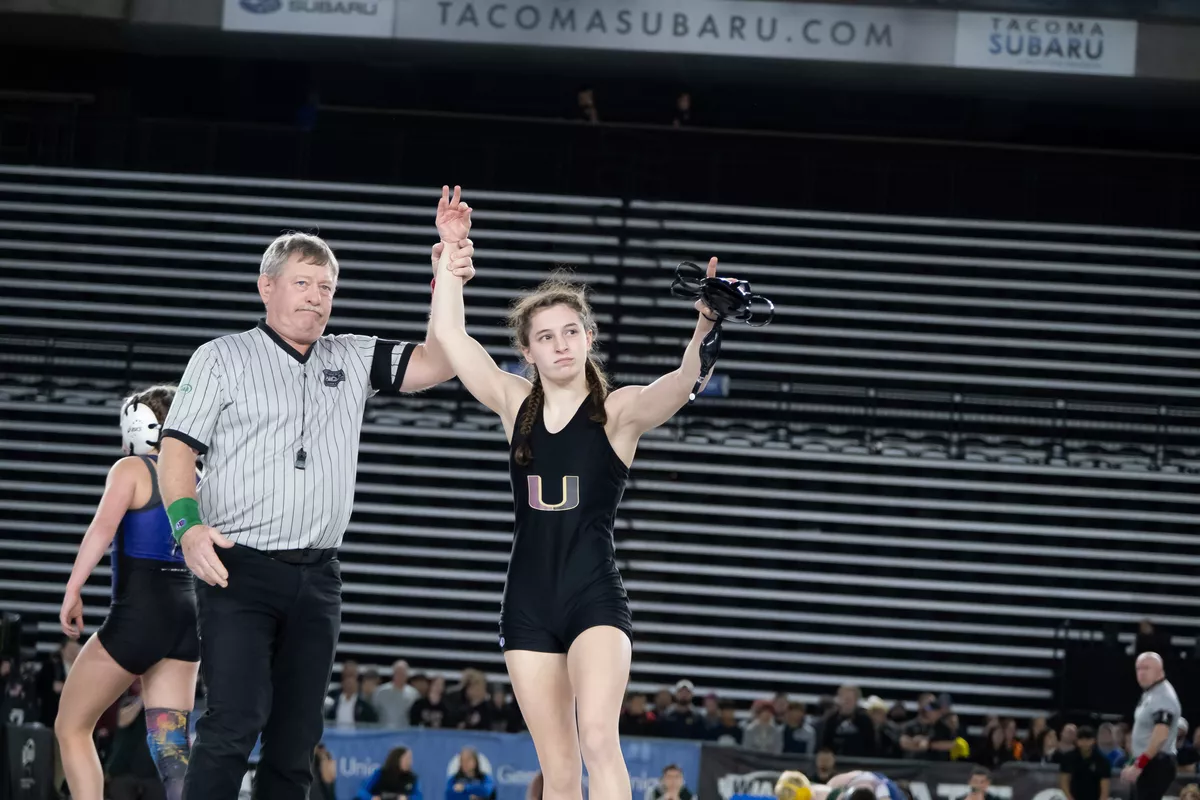 University’s Libby Roberts celebrates winning her third consecutive State 4A/3A title on Feb. 17 during Mat Classic at the Tacoma Dome.  (Madison McCord/For The Spokesman-Review)