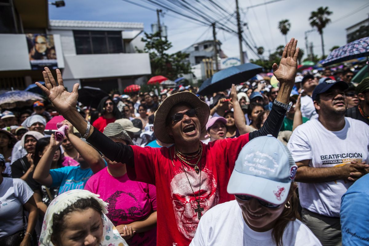 A man shouts that justice has finally been done during the beatification ceremony Saturday in San Salvador, El Salvador, for Archbishop Oscar Romero, whose image is featured on his shirt. Many of the more than 260,000 who came to witness the ceremony refer to him as “Saint Romero of the Americas.” (Associated Press)