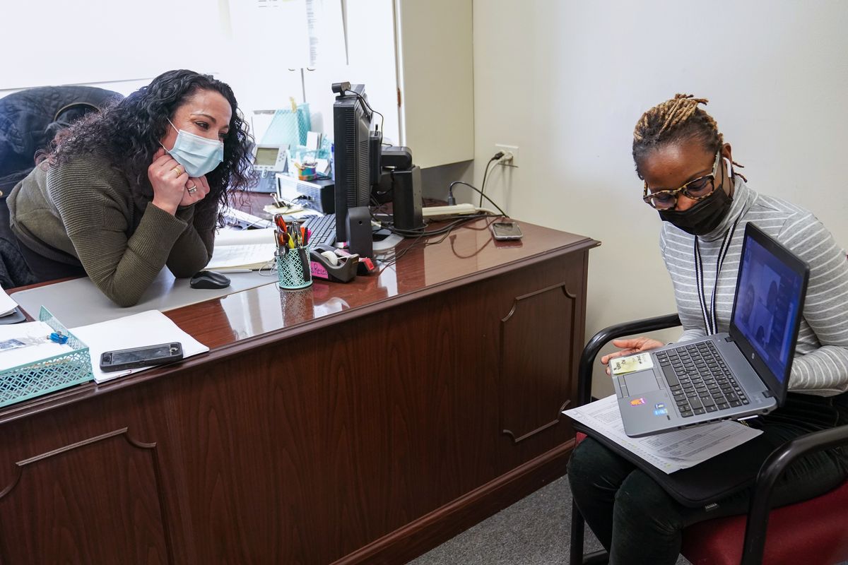High School Councilor Nadia Pearce, right, and Coordinator of School Counseling Carli Rocha-Reaes speak to a group of Juniors and Seniors via video conference, Thursday, Feb. 25, 2021, in Bridgeport. Conn. School counselors in many urban, high needs districts have been consumed with efforts to help students engage with their schoolwork since the pandemic hit.  (Mary Altaffer)