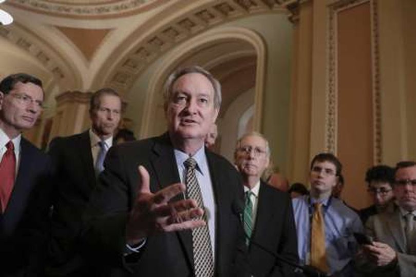 Sen. Mike Crapo, R-Idaho, chairman of the Senate Banking Committee, talks to reporters March 6, 2018. He’s joined by Sen. John Thune, R-S.D., left, and Senate Majority Leader Mitch McConnell, R-Ky., right. (AP /  J. Scott Applewhite)