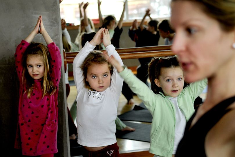 Kinder Magic students from left, Ainsley Brigham, Chase Obrien and Savannah Glass participated in a yoga class at Parkside Fitness taught by instructor Amy Gates in Coeur d'Alene. (Kathy Plonka)