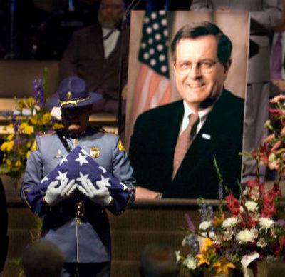 
An honor guard member presents the flag to the family of former Spokane Mayor Jim West during memorial services Friday. 
 (Christopher Anderson / The Spokesman-Review)