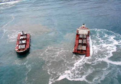 
The halves of the cargo ship sit offshore near Unalaska, Alaska.
 (Associated Press / The Spokesman-Review)