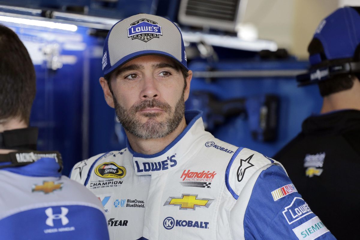 Race driver Jimmie Johnson watches his crew work in the garage area before NASCAR Sprint Cup Series auto racing practice Friday, Nov. 18, 2016, in Homestead, Fla. (Terry Renna / Associated Press)