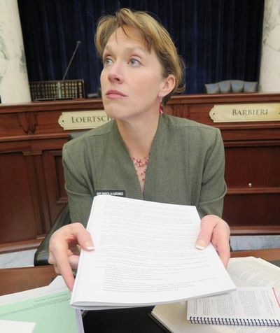 Rep. Priscilla Giddings, R-White Bird, holding a copy of the Idaho Constitution, discusses her move Monday to force the full reading of a lengthy bill to update Idaho’s notary laws. (Betsy Z. Russell)