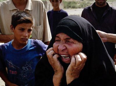 
An elderly Iraqi woman cries after identifying the body of her son in downtown Hillah, 60 miles south of Baghdad, on Wednesday. 
 (Associated Press / The Spokesman-Review)