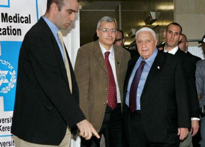 
Israeli Prime Minister Ariel Sharon, right, prepares to make a statement to journalists at Haddassah Hospital in Jerusalem on Tuesday. 
 (Associated Press / The Spokesman-Review)