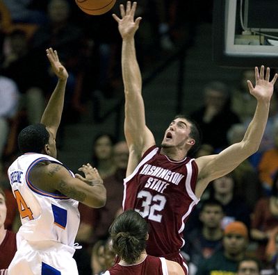 Washington State forward Daven Harmeling (32) reaches to block the shot of Boise States' Jamar Greene (4) during the second half of the college basketball game Tuesday, Nov. 13, 2007, in Boise Idaho. Washington State went on to win 86-74.  (Associated Press)