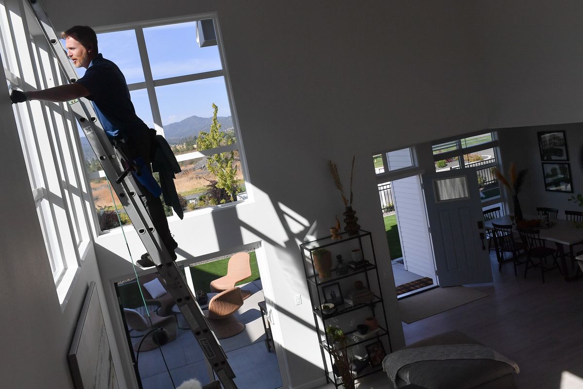 Jeremey Duncan, owner of Vista Window Cleaning, works to prepare windows for the 18th annual Spokane Home Builders Association Fall Festival of Homes, which will take place over the next two weekends beginning Friday.  (Tyler Tjomsland/The Spokesman-Review)
