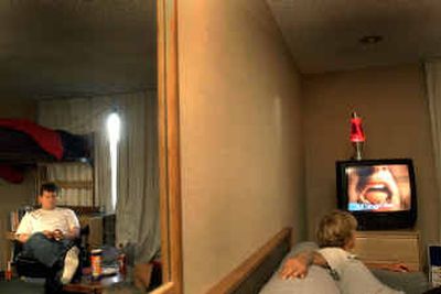 
Gonzaga sophmore Matt Madison, left, and friends watch television in his dorm room at the Red Lion River Inn in Spokane. The university is renting space at the hotel to house students.Gonzaga sophmore Matt Madison, left, and friends watch television in his dorm room at the Red Lion River Inn in Spokane. The university is renting space at the hotel to house students.
 (Brian Plonka/Brian Plonka/ / The Spokesman-Review)