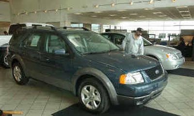 
A customer looks over a 2005 Ford Freestyle crossover vehicle at Russ Milne Ford in Macomb, Mich. 
 (Associated Press / The Spokesman-Review)