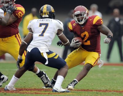 USC’s C.J. Gable, right, swerves around D.J. Campbell.  (Associated Press)