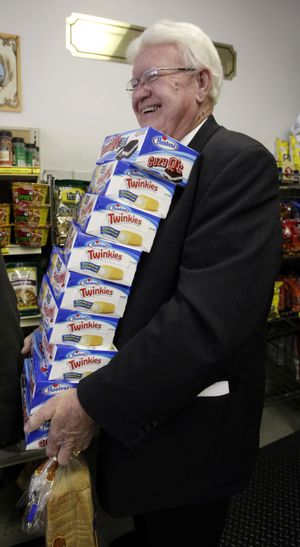 Curtis Smout stands in line with a stack of Twinkies at the Hostess Thrift Shop in Ogden, Utah, on Friday. Hostess Brands Inc., the maker of the spongy snack with a mysterious cream filling, said Friday it would shutter after years of struggling with management turmoil, rising labor costs and the ever-changing tastes of Americans. (Associated Press)