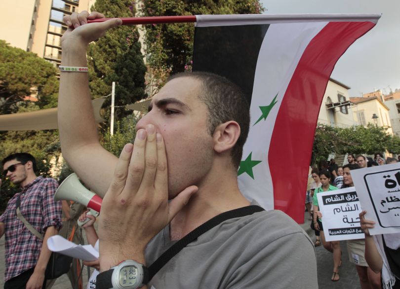 An anti-Syrian regime protester, shouts against Syrian President Bashar Assad as he protests during a demonstration to show his support to the Syrian protesters, in Beirut, Lebanon, on Monday Aug. 15, 2011. Syrian troops besieged residential areas of two key cities Monday, firing on residents as they fled for safety and killing at least two people during broad military assaults to root out dissent against President Bashar Assad's autocratic regime, witnesses said. (Hussein Malla / Associated Press)