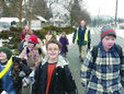 Nathan Falzone, Leviathan Warr and Matthew Grayson lead the group on the way to Pratt Elementary School last week as a part of the