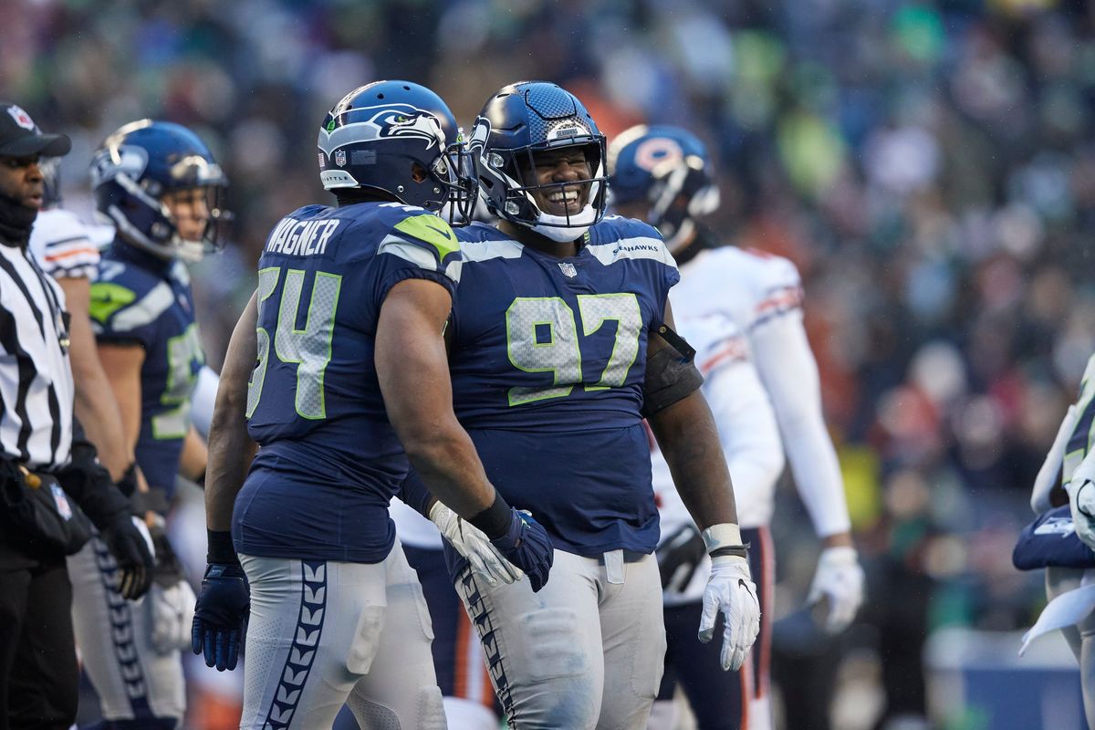 Seattle Seahawks middle linebacker Bobby Wagner (54) and defensive tackle Poona Ford (97) celebrate after a play against the Chicago Bears in the second half of an NFL football game, Sunday, Dec. 26, 2021, in Seattle. The Bears won 25-24.  (John Froschauer)