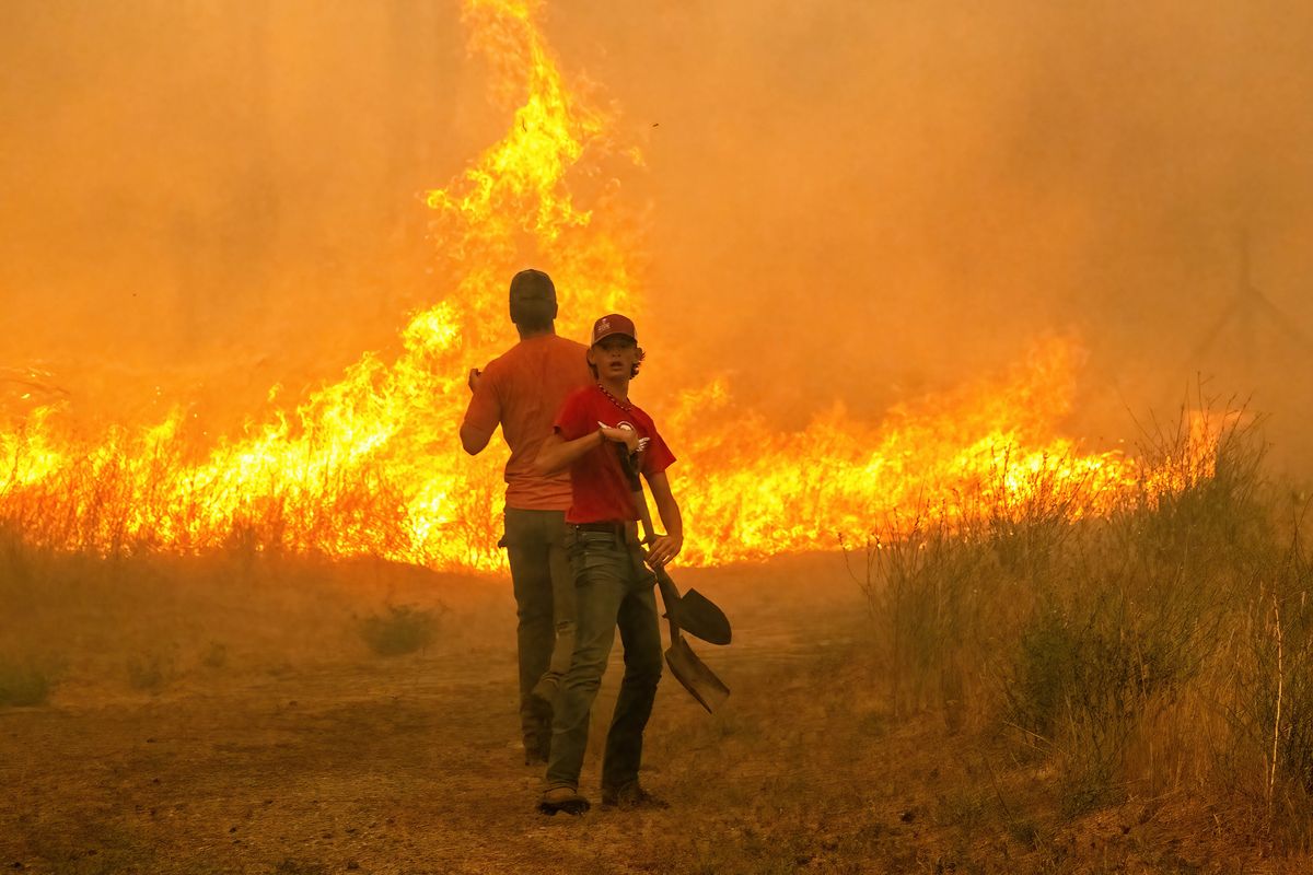 After the fire crossed I-90, locals on Granite Lake Road tried to stem the fast-moving flames with shovels.  (COLIN MULVANY/THE SPOKESMAN-REVIEW)