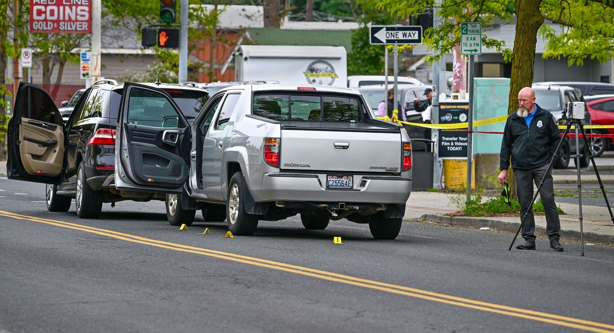 Spokane police investigate the scene Thursday of an early morning shooting at the corner of Garland Avenue and Wall Street. One person was killed, and another has been detained.  (DAN PELLE/THE SPOKESMAN-REVIEW)