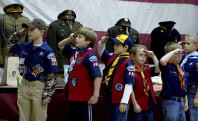 Members of the Rockford/Liberty Cub Scout Pack 488 salute the colors at the start of the Freeman Elementary and Middle School Veterans Day assembly Thursday. Below is one of the 12 mannequins dressed in uniforms from World War I through the Vietnam War that Tim Smetana brought to the assembly. This is Smetans's uncle's flight suit worn on a B-17 bomber in World War II.
(J. BART RAYNIAK photos / The Spokesman-Review)