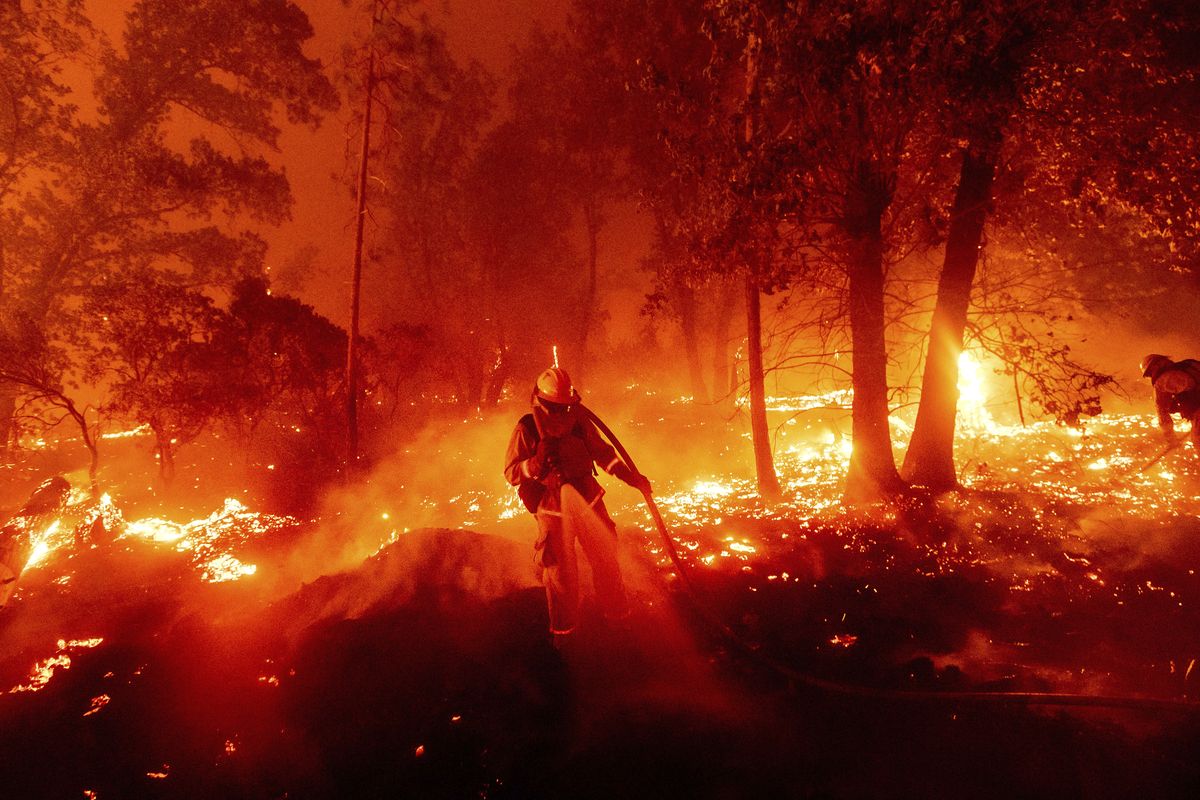 A firefighter battles the Creek Fire as it threatens homes in the Cascadel Woods neighborhood of Madera County, Calif., on Monday, Sept. 7, 2020.  (Noah Berger)