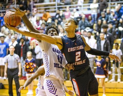 Nolan Hickman, when he played for Eastside Catholic, goes up for shot under the net against Garfield’s Tari Eason on Feb. 14, 2020, in Seattle.  (Amanda Snyder/Seattle Times)