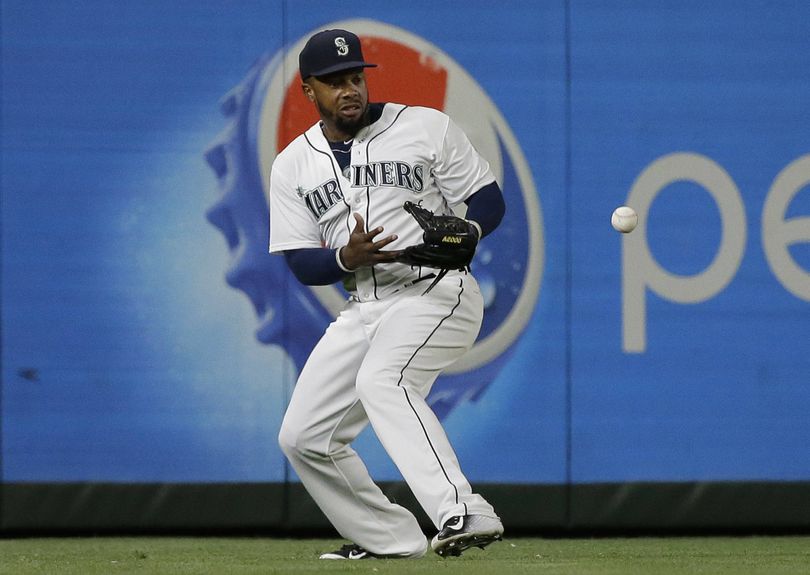 Mariners left fielder Rickie Weeks drops a fly ball in the ninth inning as Boston scores go-ahead run. (Associated Press)