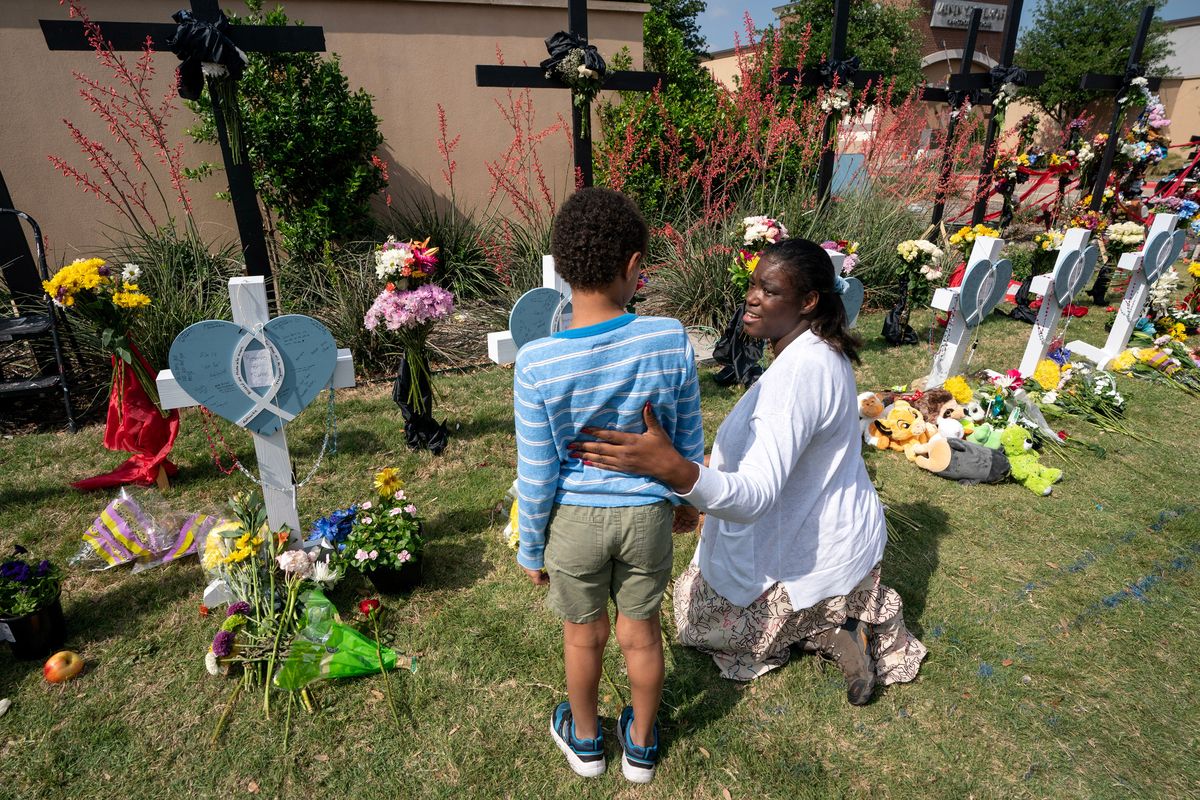 Above: Dellandra Musa reassures her son Elijiah, on Wednesday at the makeshift memorial in Allen, Texas. Left: A man writes a message at a memorial in Monterey Park, Calif., on Jan. 24, after a mass killing at a dance studio. Right: Trisha Mathews on Nov. 25, 2022, signs a personal message for one of the victims of the Walmart mass killing in Chesapeake, Va. (Jeffrey McWhorter/For The Washington Post)