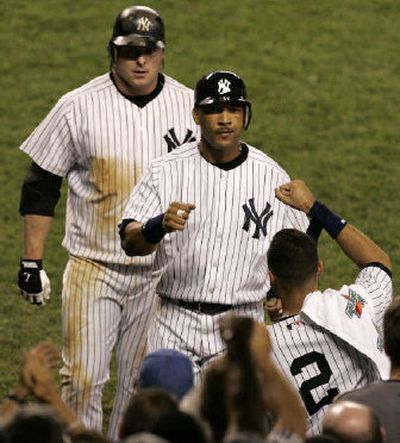 
New York's Derek Jeter (2) greets Gary Sheffield and Jason Giambi, top, after Giambi's two-run homer.
 (Associated Press / The Spokesman-Review)