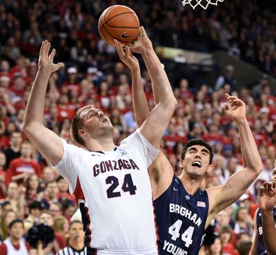 Brigham Young center Corbin Kaufusi (44) gets a hand on the ball as Gonzaga center Przemek Karnowski (24) shoots the ball in the first half of Saturday's game at McCarthey. (Colin Mulvany)