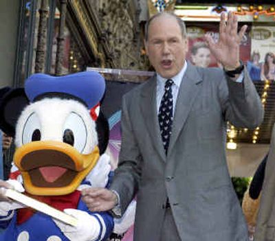 
Michael Eisner, CEO of The Walt Disney Co., waves to the crowd with Disney character Donald Duck during a ceremony honoring Donald with the 2,257th star on the Hollywood Walk of Fame last month. 
 (File/Associated Press / The Spokesman-Review)
