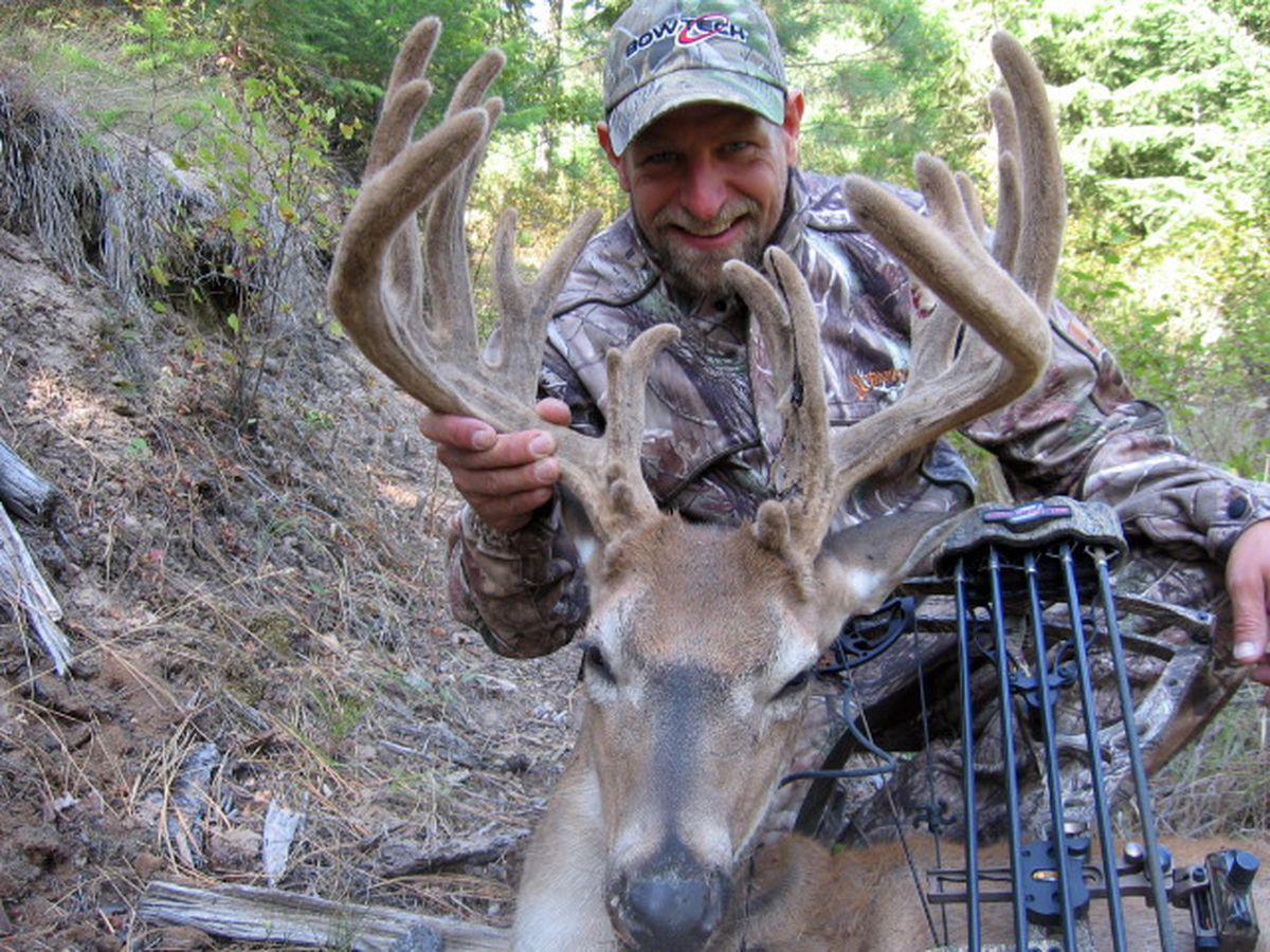 Thom Long of Spokane poses with a whitetail buck he took in September with bow and arrow after locating it with a game camera. Photo courtesy of Thom Long (Photo courtesy of Thom Long / The Spokesman-Review)