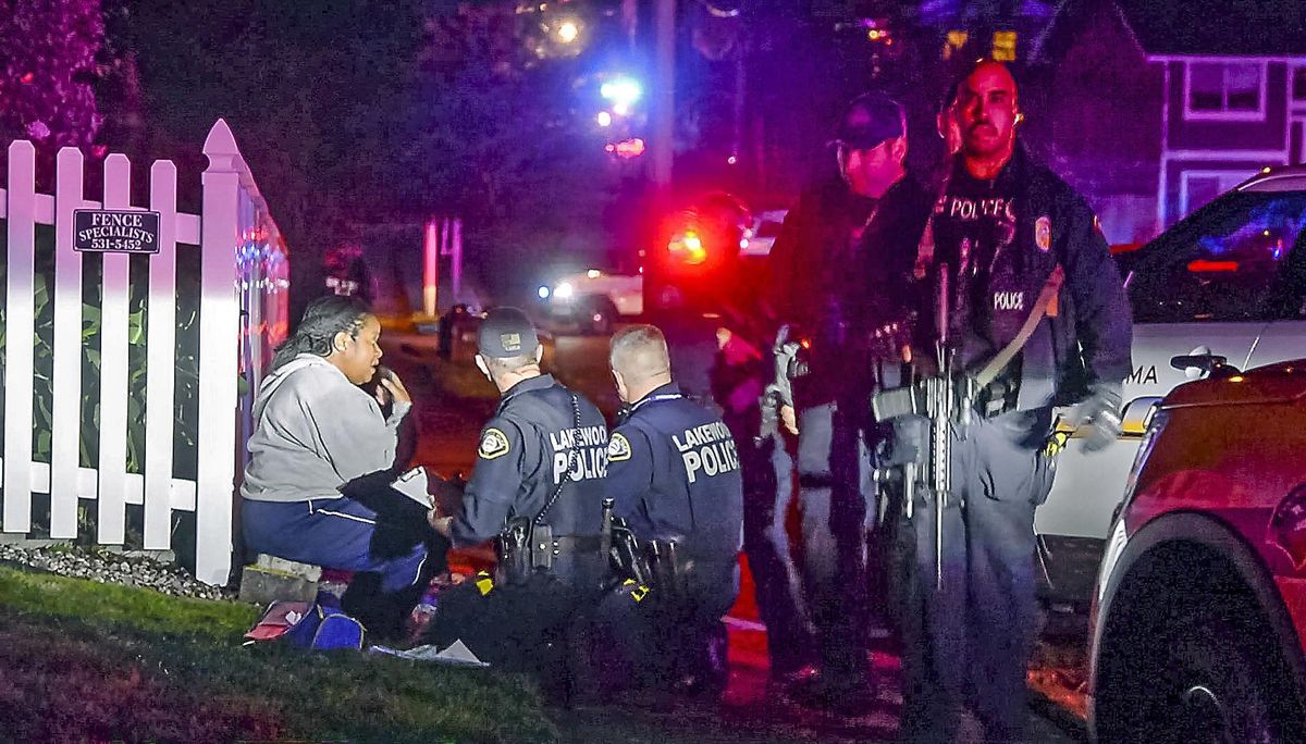 Police stand by a distraught woman at the scene where a Tacoma Police officer was shot while responding to a domestic call in East Tacoma, Wash., Wednesday, Nov. 30, 2016. (Peter Haley / AP)